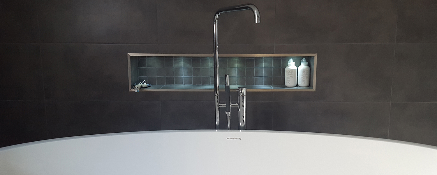 Luxury tiled bathroom with freestanding bath by PC Tiling